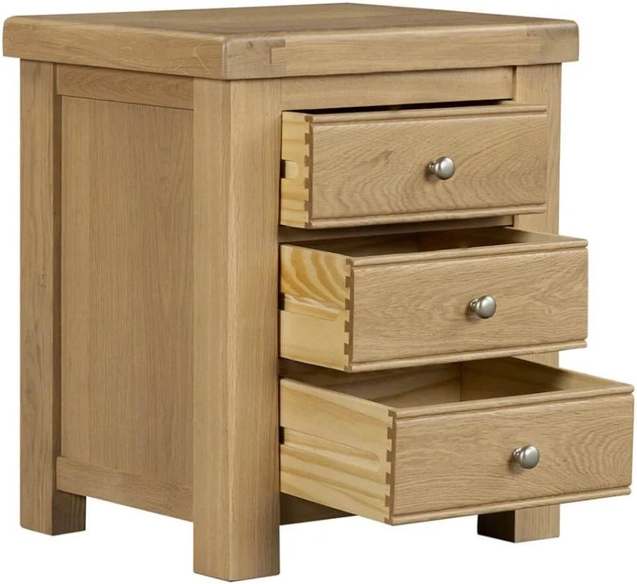 Wooden nightstand with three drawers on a white background