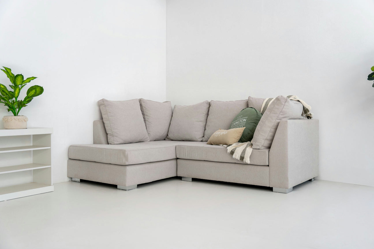 Cosy sofa with cushions and a soft throw in a bright and comfortable living space.