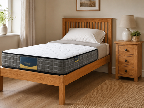 Wooden bed with a mattress in a bedroom setting