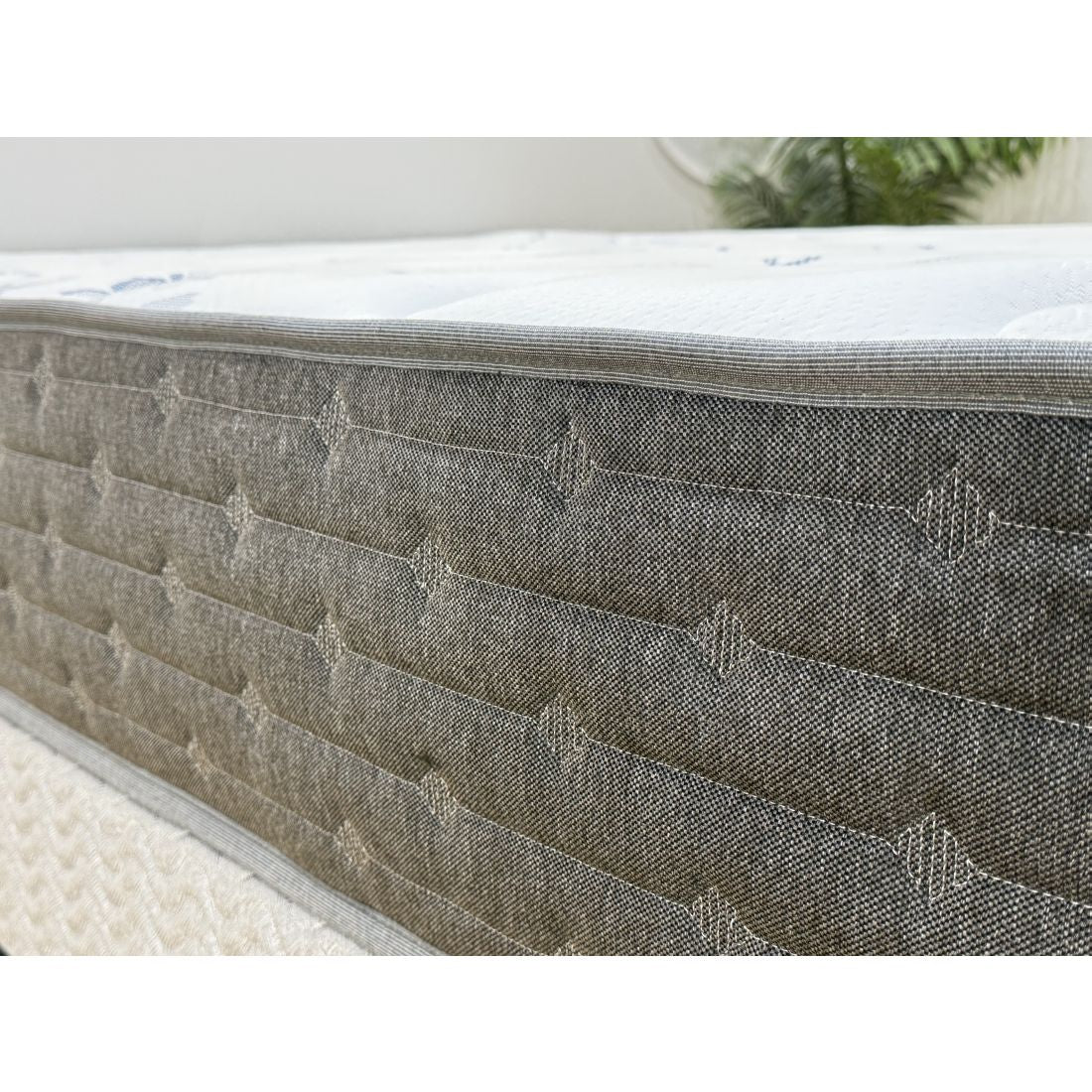 Gray mattress with quilted surface on a white background