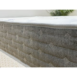Gray mattress with quilted surface on a white background
