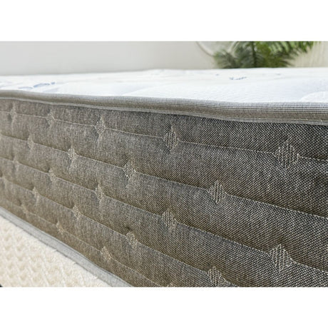 Gray mattress with quilted surface on a white background