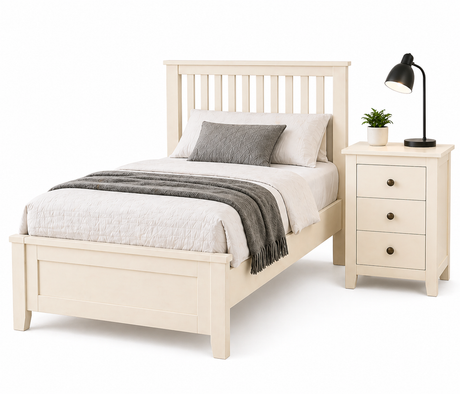 White wooden bed with bedding and a nightstand with a lamp on a white background