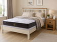 Cream ivory bed frame with slatted headboard and oak top trim, styled with a floral tufted mattress, oak one-drawer bedside table, neutral pillows, soft throw, and warm Irish bedroom décor.