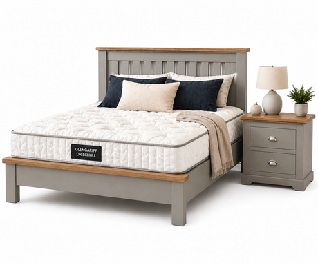 Bedroom setup with a bed, nightstand, and lamp on a white background